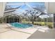 Screened-in pool area with a clear view of the backyard, offering a refreshing retreat with ample space for relaxation at 1358 Ewing St, Nokomis, FL 34275