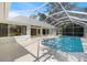 Backyard pool area with enclosed screen and view of the home at 1358 Ewing St, Nokomis, FL 34275