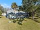 Aerial view of home with pool area; a private backyard with mature trees and a screened-in pool at 1358 Ewing St, Nokomis, FL 34275