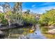 A Personal paddles a yellow kayak along the river, showcasing the waterfront lifestyle at 1358 Ewing St, Nokomis, FL 34275