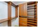 Custom wood shelving and drawers in a spacious walk-in closet provides ample storage space at 1358 Ewing St, Nokomis, FL 34275