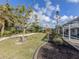 Spacious landscaped backyard with a view of the screened-in pool at 17 Brentwood Ln, Englewood, FL 34223