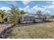 Backyard featuring landscaped yard with a screened-in pool enclosure at 17 Brentwood Ln, Englewood, FL 34223