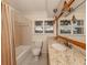 Bathroom featuring granite vanity, bathtub, and shower combination at 17 Brentwood Ln, Englewood, FL 34223