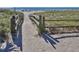 Pathway to the beach with weathered wooden fence leading to the sandy shores and ocean at 17 Brentwood Ln, Englewood, FL 34223