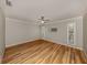 Bright bedroom featuring hardwood flooring, a ceiling fan, and windows for natural light at 17 Brentwood Ln, Englewood, FL 34223