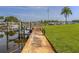 View of the community boat docks with boat slips and walkway offering convenient access to the canal at 17 Brentwood Ln, Englewood, FL 34223