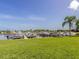 View of the community boat docks with boat slips and green lawn, offering convenient access to the water at 17 Brentwood Ln, Englewood, FL 34223