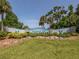 Beautifully landscaped entrance to Englewood Isles with lush greenery, rocks, and a decorative community sign at 17 Brentwood Ln, Englewood, FL 34223