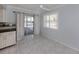 Dining area adjacent to the kitchen with sliding glass doors and bright windows at 17 Brentwood Ln, Englewood, FL 34223