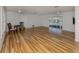 Bright living room with light hardwood floors, ceiling fans, and sliding glass doors leading to the pool area at 17 Brentwood Ln, Englewood, FL 34223