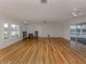 Spacious living room with hardwood floors, ceiling fans, natural light, and a view of the pool at 17 Brentwood Ln, Englewood, FL 34223