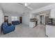 Open-concept living room adjacent to the kitchen with tile flooring and bright windows at 17 Brentwood Ln, Englewood, FL 34223