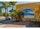 Decorative beach-themed mural on a building with tropical plants, adding local charm at 17 Brentwood Ln, Englewood, FL 34223