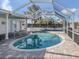 Screened-in pool area featuring an in-ground pool and brick paver flooring at 17 Brentwood Ln, Englewood, FL 34223