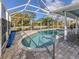 Screened-in pool area with a beautiful pool, brick pavers, and well-maintained landscaping at 17 Brentwood Ln, Englewood, FL 34223