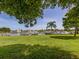 Scenic view of the community boat docks and canal from a grassy area under the shade of mature trees at 17 Brentwood Ln, Englewood, FL 34223