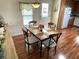 Cozy dining area with wood table, four chairs, and natural light near the kitchen at 210 Schooner St, North Port, FL 34287