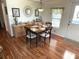 Inviting dining area with stylish wood look flooring and a decorative light fixture at 210 Schooner St, North Port, FL 34287