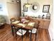 Inviting dining area with stylish wood look flooring and a decorative light fixture at 210 Schooner St, North Port, FL 34287