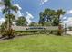 Well-maintained Harbor Isles community entrance sign surrounded by lush landscaping at 210 Schooner St, North Port, FL 34287