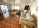 Spacious living room featuring hardwood floors and comfortable seating arrangement at 210 Schooner St, North Port, FL 34287