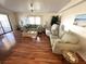 Bright living room with large windows, wood floors, and neutral decor at 210 Schooner St, North Port, FL 34287