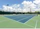 Well-maintained tennis court featuring a classic blue and green surface, perfect for friendly matches at 210 Schooner St, North Port, FL 34287