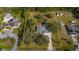 Aerial view of property showing expansive yard, mature trees and neighboring homes in a serene, suburban neighborhood setting at 2537 Northway Dr, Venice, FL 34292