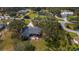 Captivating aerial view of a single-story home with mature trees and a red umbrella on the back patio at 2537 Northway Dr, Venice, FL 34292