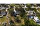 An aerial view of homes with mature trees shows roof types, yard size, and proximity to neighbors and streets in the community at 2537 Northway Dr, Venice, FL 34292