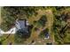 Aerial view of property showing roof condition, yard size, and outbuildings surrounded by mature trees and lush landscapes at 2537 Northway Dr, Venice, FL 34292