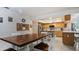 Dining area with wood table, and direct view into a modern kitchen with stainless steel appliances at 2537 Northway Dr, Venice, FL 34292