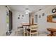 Cozy dining area with a wood table, white wainscoting, and backyard access at 2537 Northway Dr, Venice, FL 34292