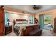 Relaxing main bedroom with a king bed, ceiling fan, and access to a private patio at 2537 Northway Dr, Venice, FL 34292