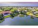 Aerial view of the neighborhood with lake and beautiful landscaping at 3 Inlets Blvd # 3, Nokomis, FL 34275