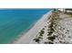 Scenic beach view with turquoise water and white sand, near residential buildings on a sunny day at 3 Inlets Blvd # 3, Nokomis, FL 34275