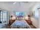 Well-lit bedroom with a large window and wood floors at 3 Inlets Blvd # 3, Nokomis, FL 34275