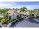 Exterior view of a well-maintained single-story home with beautiful landscaping, a covered entryway, and paved parking at 3 Inlets Blvd # 3, Nokomis, FL 34275