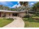 Exterior of the community clubhouse and manicured lawn at 3351 Ramblewood Ct # 3351, Sarasota, FL 34237