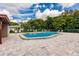 Sparkling community pool with lounge chairs surrounded by lush landscaping and blue skies at 3351 Ramblewood Ct # 3351, Sarasota, FL 34237