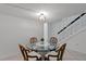 Bright dining space featuring a round glass table with four white cushioned chairs at 3351 Ramblewood Ct # 3351, Sarasota, FL 34237