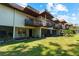 Low angle view of multiple units with balconies overlooking a manicured green space at 3351 Ramblewood Ct # 3351, Sarasota, FL 34237