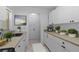 A bright kitchen with white cabinets and neutral countertops and a double basin sink at 3351 Ramblewood Ct # 3351, Sarasota, FL 34237