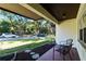 Covered front patio with chairs, lush landscaping, and street view at 3351 Ramblewood Ct # 3351, Sarasota, FL 34237