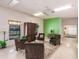 Seating area in the recreation room with neutral tones and green accent wall at 3351 Ramblewood Ct # 3351, Sarasota, FL 34237