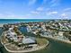 Scenic aerial view of a waterfront community featuring a tranquil canal, lush landscaping, and charming waterfront homes at 4074 N Beach Rd # Ctg5, Englewood, FL 34223