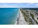 Picturesque beachfront community with stunning views of the ocean, featuring a sandy beach and clear turquoise waters at 4074 N Beach Rd # Ctg5, Englewood, FL 34223