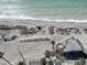 Aerial view of the beachfront property with surrounding palm trees at 4074 N Beach Rd, Englewood, FL 34223