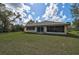 An exterior view of the backyard with a well-maintained lawn and room for outdoor enjoyment at 4344 Ozark Ave, North Port, FL 34287